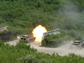 A Taiwanese tank fires at targets during a military exercise in Hengchun, Pingtung county in southern Taiwan on Wednesday, Sept. 7, 2022. Taiwan on Tuesday launched military exercises on the Hengchun Peninsula in the far south of the island simulating ground warfare against an invading enemy, aided by tanks and Apache attack helicopters.