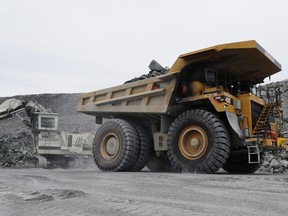 Gold miners work in the open pit mine at Agnico-Eagle's Meadowbank Mine facility in Meadowbank Mine, Nunavut on Wednesday, August 24, 2011. The mine is situated 75 km north of the hamlet of Baker Lake.