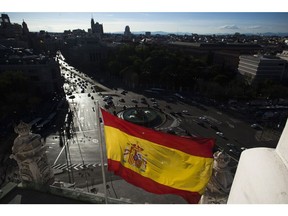 A Spanish national flag flies from a building on Cibeles square in Madrid.