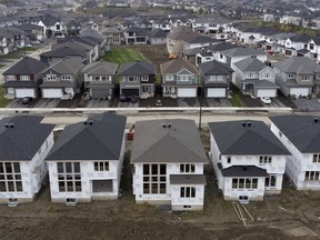 In this photo taken using a drone, homes under construction are seen in a new suburb in Ottawa, Friday, Oct. 15, 2021. Home sales figures from the real estate boards in some of Canada's largest cities are expected this week.