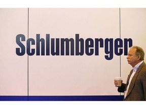 An attendee walks past Schlumberger Ltd. signage during the 2017 Offshore Technology Conference (OTC) in Houston, Texas, U.S., on Wednesday, May 3, 2017. The OTC gathers energy professionals to exchange ideas and opinions to advance scientific and technical knowledge for offshore resources. Photographer: Aaron M. Sprecher/Bloomberg