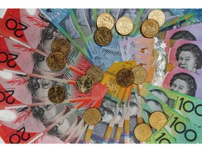 Australian dollar banknotes of various denominations and one dollar coins are arranged for a photograph in Sydney, Australia, on Friday, Aug. 4, 2017. The Australian dollar rose for the first time in six days after an index showed business confidence improved last month and iron ore prices extended gains.