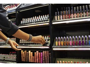 An employee assists a customer with MAC Cosmetics Inc. lipstick at an Ulta Beauty Inc. store in New York, U.S., on Thursday, May 31, 2018. Ulta reported late Thursday that its comparable sales rose 8.1 percent in the first quarter from a year earlier. The increase was driven by all the right
