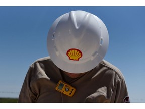 A logo is displayed on the hardhat of a worker at the Royal Dutch Shell Plc processing facility in Loving, Texas, U.S., on Friday, Aug. 24, 2018. Royal Dutch Shell Plc came through a quarter of volatile oil prices to beat earnings estimates, delivering a surge in cash flow the company said will underpin "world-class" returns to investors. Photographer: Callaghan O'Hare/Bloomberg