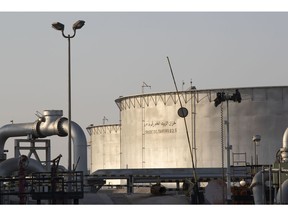 Crude oil storage tanks stand at Saudi Aramco's Abqaiq crude oil plant in Saudi Arabia. Photographer: Faisal Al Nasser/Bloomberg