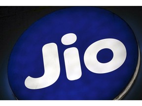 The logo of Reliance Jio, the mobile network of Reliance Industries Ltd., is displayed at a store in Mumbai, India, on Sunday, Jan. 19, 2020. Reliance Industries, India's biggest company by market value, posted a 13.5% jump in quarterly net income as growth in telecom and retail business helped outweigh a slump in petrochemical operations.