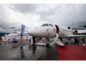 A Dassault Aviation SA Falcon 8X private jet, right, stands on display during the Singapore Airshow at the Changi Exhibition Centre in Singapore, on Tuesday, Feb. 11, 2020. Plane makers and airlines are exploring new designs to reduce fuel burn and cut carbon emissions in a warming climate. Blending the wings with the fuselage to cut drag is one of several possible solutions. Photographer: SeongJoon Cho/Bloomberg