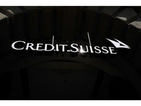 An illuminated logo hangs above the entrance to the Credit Suisse Group AG headquarters in Zurich, Switzerland, on Friday, April 17, 2020. Credit Suisse compensated managers and employees with additional shares in the bank after the price dropped sharply during the depths of a market correction spurred by the coronavirus outbreak. Photographer: Stefan Wermuth/Bloomberg