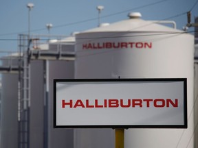 Halliburton Co. signage is displayed alongside storage tanks in Port Fourchon, Louisiana, U.S., on Thursday, June 11, 2020. Oil eclipsed $40 a barrel in New York on Friday, extending a slow but relentless rise thats been fueled by a pick-up in demand and could signal a reawakening for U.S. shale production. Photographer: Luke Sharrett/Bloomberg via Getty Images