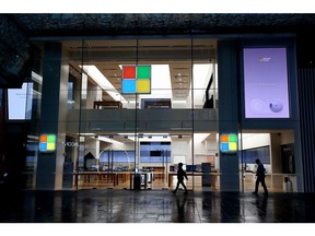 Pedestrians walk past a closed Microsoft Corp. store at the near deserted Pitt Street Mall during a lockdown imposed due to the coronavirus, at night in Sydney, Australia, on Tuesday, June 29, 2021. Close to half of Australia's population is now in lockdown as the nation struggles to contain a spread of the delta coronavirus variant.