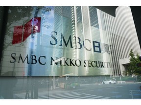 The logo of SMBC Nikko Securities Inc., a unit of Sumitomo Mitsui Financial Group Inc., outside its head office in Tokyo, Japan, on Thursday, Oct. 14, 2021. The Bank of Japan and Financial Services Agency are assessing if local financial institutions have any remaining Libor-linked contracts that will be difficult to shift to alternative interest rates before the benchmark expires. Photographer: Toru Hanai/Bloomberg
