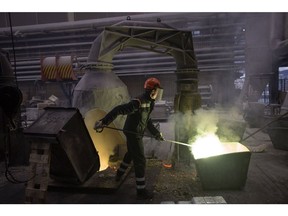 A worker uses a rod to stir a mixture of molten copper and zinc in the foundry at the Valjaonica Bakra Sevojno AD copper mill in Sevojno, Serbia, on Tuesday, Oct. 26, 2021. For months, the copper market has been caught in a tug of war between steadily shrinking supplies on one side, and an increasingly strained global economy on the other. Photographer: Oliver Bunic/Bloomberg