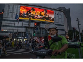 A screen displaying a People's Liberation Army (PLA) advertisement at a crossroad in Beijing, China, on Tuesday, Aug. 30, 2022. The Chinese Communist Partys twice-a-decade leadership congress will begin on Oct. 16, state media said, bringing President Xi Jinping a step closer to a precedent-defying third term in power.