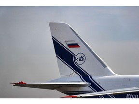 Livery for Volga-Dnepr Group and the Russian flag on the tail fin of an Antonov An-124 strategic airlift cargo aircraft at Leipzig/Halle Airport in Schkeuditz, Germany, on Wednesday, March 2, 2022. Russia's invasion of Ukraine has sidelined a fleet of massive air freighters that oil companies and engineering firms rely on to carry oversize items such as helicopters, power turbines and are even used for spacecraft.