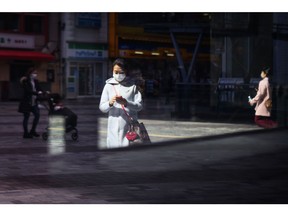 Pedestrians in Tokyo, Japan on Monday, March 7, 2022. Japan's decision to extend the duration of semi-emergency virus restrictions in Tokyo and 17 other prefectures will put further pressure on an economy that some analysts say will contract this quarter.