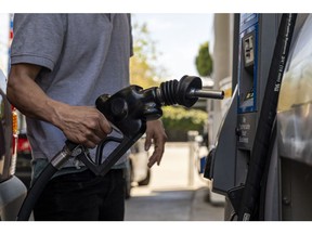 A driver returns a fuel nozzle to a gas pump at a Chevron gas station in San Francisco, California, U.S., on Monday, March 7, 2022. The average price of gasoline in the U.S. jumped above $4 a gallon for the first time since 2008 in a clear sign of the energy inflation that's hurt consumers since Russia invaded Ukraine. Photographer: David Paul Morris/Bloomberg