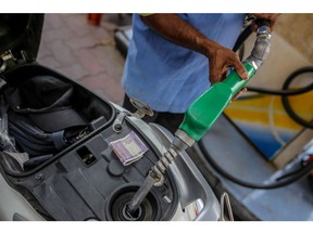 An attendant fills a motorbike with fuel at a Bharat Petroleum Corp. gas station in Hyderabad, India, on Wednesday, March 23, 2022. India's urban consumption is driving recovery from late pandemic wave but has further intensified the divergence between cities and the hinterland, according to a report by Citigroup Inc released last week. Photographer: Dhiraj Singh/Bloomberg