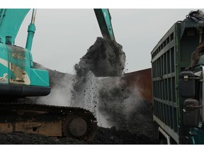An excavator loads coal onto a dump truck at Cirebon Port in West Java, Indonesia, on Wednesday, May 11, 2022. Trade has been a bright spot for Indonesia, which has served as a key exporter of coal, palm oil and minerals amid a global shortage in commodities after Russia's invasion of Ukraine. Photographer: Dimas Ardian/Bloomberg