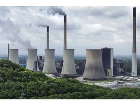 Chimneys and a cooling tower emit vapor at the Scholven coal-fired power plant operated by Uniper SE in Gelsenkirchen, Germany, on Saturday, May 21, 2022. S&P Global Ratings last week downgraded Uniper to the lowest investment grade level, a move that could prompt lenders to restrict access to credit and peers to demand more collateral to back trades. Photographer: Alex Kraus/Bloomberg