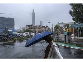 A pedestrian passes the Taipei 101 building in Taipei, Taiwan, on Tuesday, May 24, 2022. US President Joe Biden is seeking to show US resolve against China, yet an ill-timed gaffe on Taiwan risks undermining his bid to curb Beijing's growing influence over the region.
