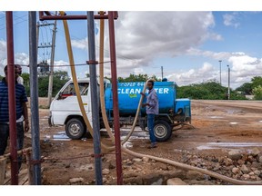 A worker fills a water truck, that delivers water to remote communities, from a pump in Garissa, Kenya, on Friday, May 20.