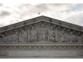 A bird flies over the US Supreme Court in Washington, D.C., US, on Monday, June 27, 2022. A CBS News poll suggested that a majority of Americans disapprove of the Supreme Court's decision overturning the constitutional right to an abortion, which is inflaming a partisan divide on display in comments by senior lawmakers. Photographer: Amanda Andrade-Rhoades/Bloomberg