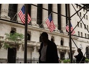 Pedestrians outside the New York Stock Exchange (NYSE) in New York, US, on Monday, July 18, 2022. US stocks fell amid a drop in big tech as investors assessed the outlook for corporate profits and risks to economic growth as central banks hike interest rates to combat runaway inflation.