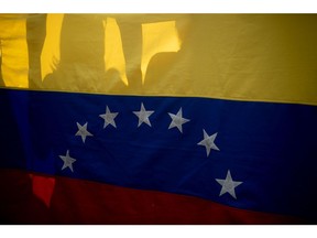 Demonstrators hold a Venezuelan flag during a workers's rights protest in Caracas, Venezuela, on Thursday, Aug. 11, 2022. Venezuela's annual inflation reached 139% while a basket of food for a household reached $392 in July, the highest year-over-year. Photographer: Carolina Cabral/Bloomberg
