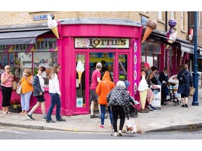 Shoppers pass an ice cream parlour in Whitstable, UK, on Tuesday, Aug 16, 2022. Inflation, which is at a 40-year high and set to accelerate, meant the volume of goods purchased declined even as the value of spending increased, the British Retail Consortium said.