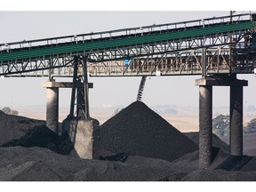A conveyor bridge over piles of coal at the Mafube open-cast coal mine, operated by Exxaro Resources Ltd. and Thungela Resources Ltd., in Mpumalanga, South Africa on Friday, Sept. 9, 2022. South Africa relies on coal to generate more than 80% of its electricity, and has been subjected to intermittent outages since 2008 because state utility Eskom Holdings SOC Ltd. can't meet demand from its old and poorly maintained plants. Photographer: Waldo Swiegers/Bloomberg