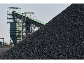 A pile of coal at the Mafube open-cast coal mine, operated by Exxaro Resources Ltd. and Thungela Resources Ltd., in Mpumalanga, South Africa on Friday, Sept. 9, 2022. South Africa relies on coal to generate more than 80% of its electricity, and has been subjected to intermittent outages since 2008 because state utility Eskom Holdings SOC Ltd. can't meet demand from its old and poorly maintained plants. Photographer: Waldo Swiegers/Bloomberg