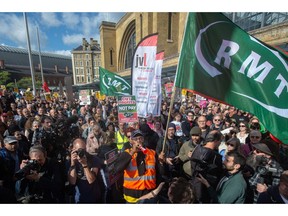 LONDON, ENGLAND - OCTOBER1: Thousands of people attend the Enough is Enough strike rally outside Kings Cross station on October 1, 2022 in London, England. Today the UK Government's £150bn energy price guarantee comes into effect with average annual household bills expected to rise to £2500. People are protesting this rise nationwide by burning their bills and gathering at rallies across the nation.