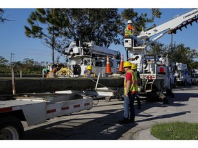Florida Power & Light Co. (FPL) emergency response team workers following Hurricane Ian in Fort Myers, Florida, US, on Sunday, Oct. 2, 2022. Five days after Hurricane Ian slammed into Florida, bringing with it a deadly storm surge, catastrophic flooding and powerful winds, the death and destruction it has wrought are starting to become clearer.