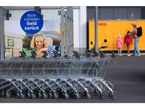 A line of shopping carts outside a Lidl Stiftung & Co. KG supermarket in Berlin, Germany, on Tuesday, Oct. 4, 2022. German inflation for August reached double digits for the first time since the euro was introduced more than 20 years ago, surging more than anticipated after temporary government-relief measures ended and Europe's energy crisis worsened.
