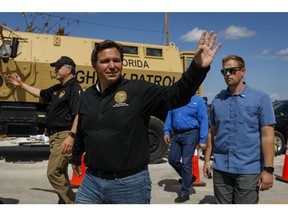 Ron DeSantis, governor of Florida, waves as he arrives to a news conference in Matlacha, Florida, US, on Wednesday, Oct. 5, 2022. DeSantis and President Biden have feuded over political issues, including migrants, but are coordinating on assistance for Floridians hit by a hurricane Biden's called "among the worst in the nation's history."