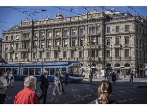 A tram passes the Credit Suisse Group AG headquarters in Zurich, Switzerland, on Wednesday, Oct. 5, 2022. Credit Suisse has become a poaching ground for rivals in recent times, with the lender struggling to contain the fallout of a series of scandals and flagging performance.