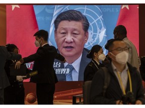 BEIJING, CHINA -OCTOBER 15: A video screen shows Chinese President Xi Jinping as security check visitors at the press centre for the 20th National Congress of the Communist Party of China in a closed loop hotel to prevent the spread of COVID-19 on October 15 , 2022 in Beijing, China. The ruling Communist Party of China will open its 20th Party Congress on October 16th and Xi Jinping is widely expected to secure a third term in power.
