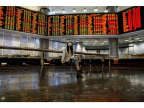A person looks at stock prices displayed inside the trading gallery of the RHB Investment Bank Bhd. headquarters in Kuala Lumpur, Malaysia, on Tuesday, Oct. 11, 2022. Malaysia's stocks and the ringgit weakened after Prime Minister Ismail Sabri Yaakob announced the dissolution of parliament on Monday, paving the way for elections this year. Photographer: Samsul Said/Bloomberg