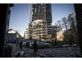 Destroyed cars stand amid damage caused by a missile strike in a residential area near Tower 101 not far from Kyiv's main train station on October 11. Photographer: Ed Ram/Getty Images