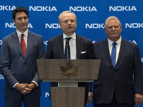 Prime Minister Justin Trudeau and Ontario Premier Doug Ford listen to Pekka Lundmark, CEO of Nokia, respond to a question following the announcement Monday of a major investment in Ontario.
