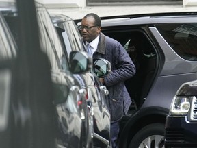 Britain's Chancellor of the Exchequer Kwasi Kwarteng arrives in Downing Street after returning from the US, in London, Friday, Oct. 14, 2022. The British government says Prime Minister Liz Truss will hold a news conference Friday as she faces pressure to U-turn on an economic package that sparked market turmoil. The announcement comes after Treasury chief Kwasi Kwarteng cut short a visit to Washington to fly back to London for crisis talks.