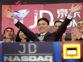FILE - Liu Qiangdong, also known as Richard Liu, CEO of JD.com, raises his arms to celebrate the IPO for his company at the Nasdaq MarketSite, in New York on May 22, 2014. Liu has agreed to settle lawsuit from a former University of Minnesota student who alleges he raped her after a night of dinner and drinks in 2018 according to a statement released Saturday, Oct. 2, 2022.