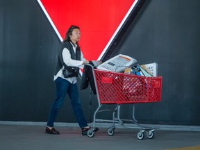 A woman exits a Canadian Tire store in Toronto.