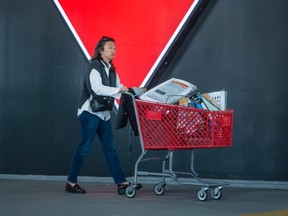A woman walks out of a Canadian Tire store in Toronto.