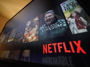 The Netflix menu is shown on a screen. Netflix joins an array of new ad-supported streaming options when it launches the cheaper tier of its service on Nov. 1.