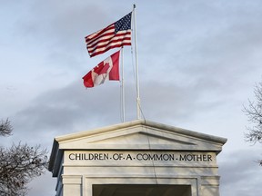 The U.S. and Canadian flags at the Peace Arch border crossing in Blaine, Washington.