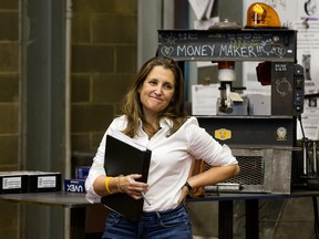 Chrystia Freeland stands beside a machine used to test welds prior to a press conference during a visit to the International Brotherhood of Boilermakers in Edmonton, on Oct. 20.