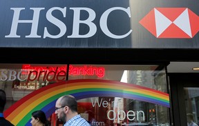 Pedestrians pass an HSBC bank branch in Toronto.