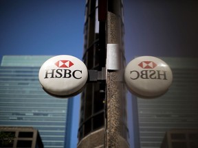 HSBC Holdings Plc signage hangs outside a bank branch in the financial district of Toronto.