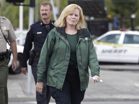 FILE - Santa Clara County Sheriff Laurie Smith walks to a news conference in Cupertino, Calif., Wednesday, Oct. 5, 2011. A former manager for a security company who implicated a Santa Clara County Sheriff's captain and others in an alleged bribery scheme to trade political donations supporting the sheriff in exchange for concealed-carry weapons has testified in the civil corruption trial against her. Smith has not been directly implicated in the two criminal indictments that ensnared her undersheriff and a captain. But if the jury finds just one count to be true, she would be removed from office early.
